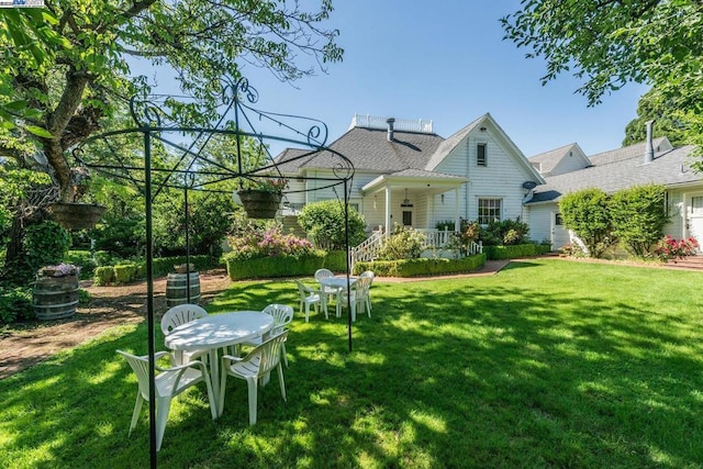 rear view of house featuring a yard