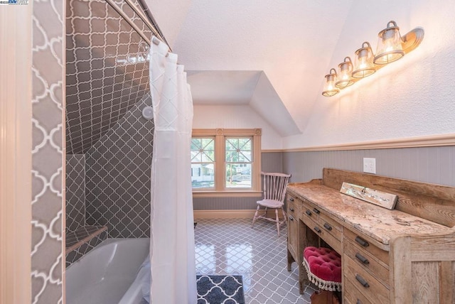 bathroom with vaulted ceiling and shower / bath combo with shower curtain