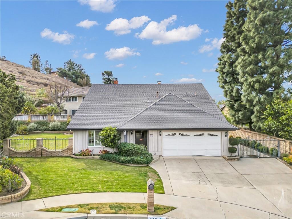 view of front of home with a garage and a front lawn