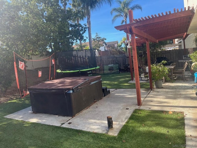 view of patio / terrace featuring a pergola, a hot tub, and a trampoline