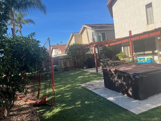 view of yard featuring a hot tub and a pergola