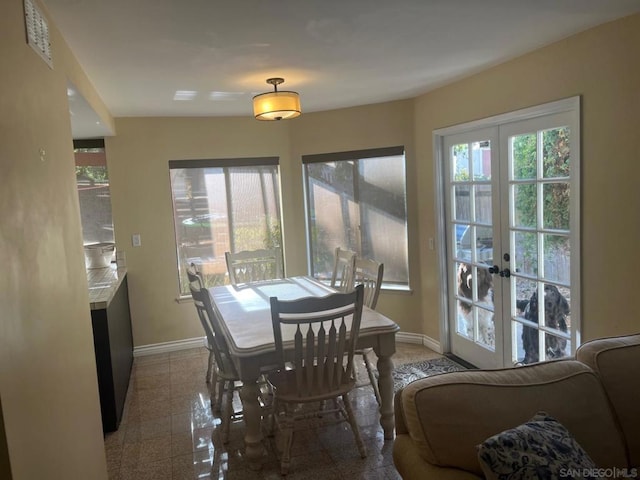 dining area with a fireplace and french doors