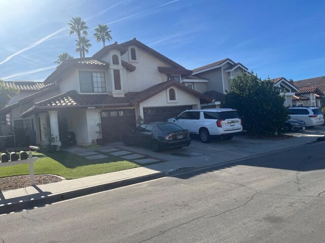 view of property featuring a front yard and a garage