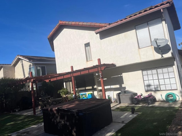 back of property featuring a pergola and a patio