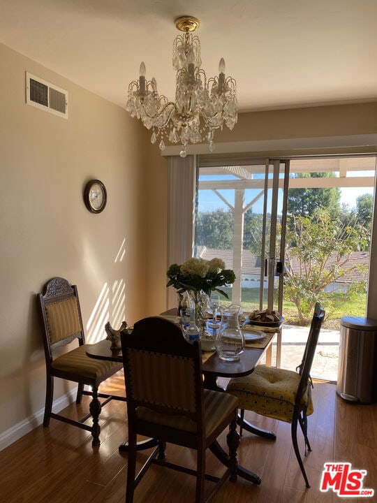 dining room featuring a chandelier and dark hardwood / wood-style floors