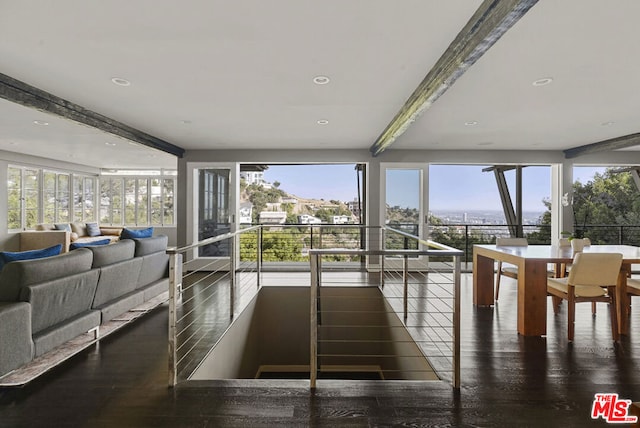 sunroom / solarium featuring plenty of natural light and beamed ceiling