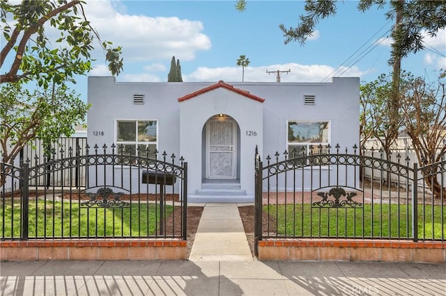 mediterranean / spanish-style home with a front yard