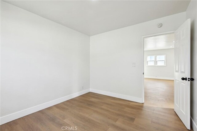 spare room with hardwood / wood-style flooring