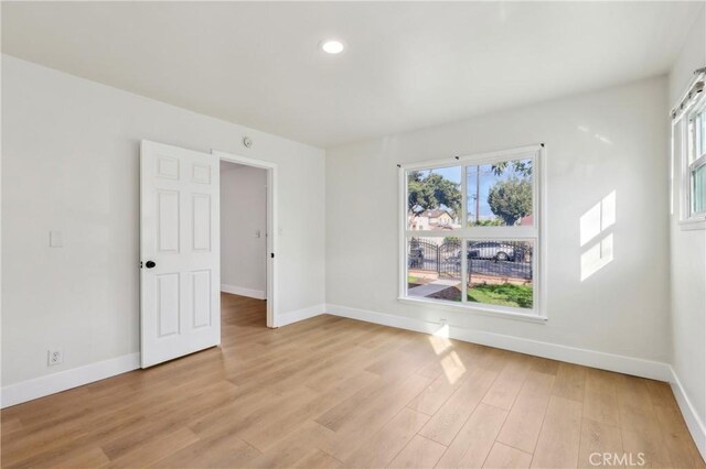 spare room with light hardwood / wood-style flooring