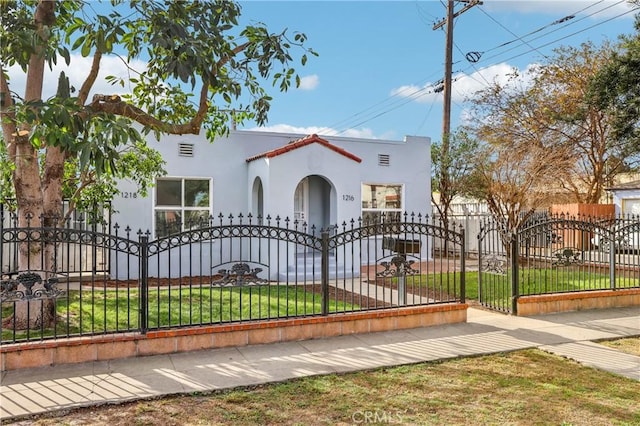 mediterranean / spanish home featuring a front yard