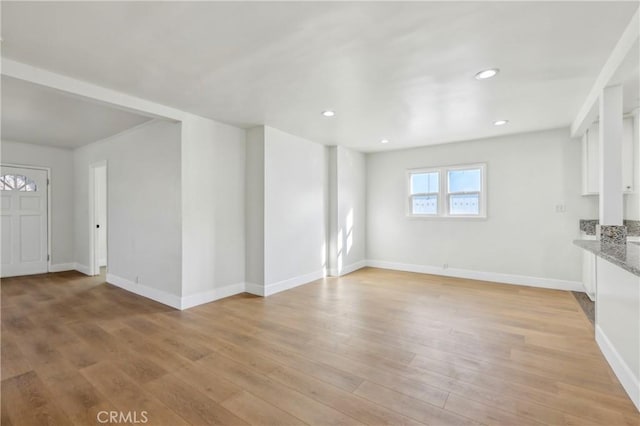 unfurnished living room with light hardwood / wood-style flooring