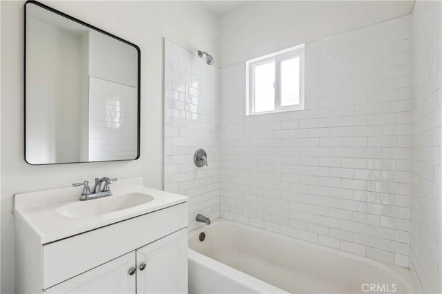 bathroom featuring washtub / shower combination and vanity