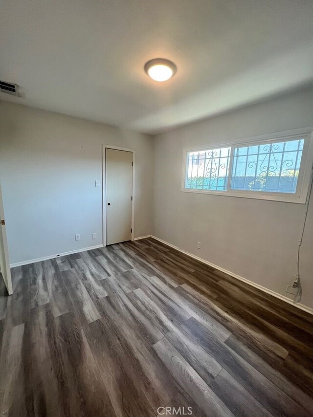 unfurnished room featuring dark hardwood / wood-style floors