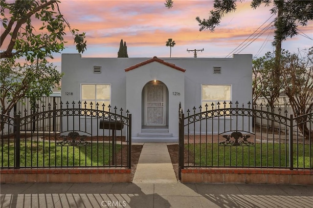 view of front of property with a lawn