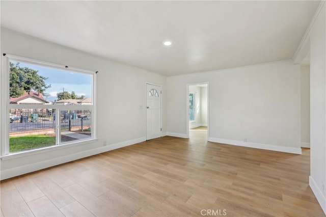 unfurnished room featuring light hardwood / wood-style flooring and plenty of natural light