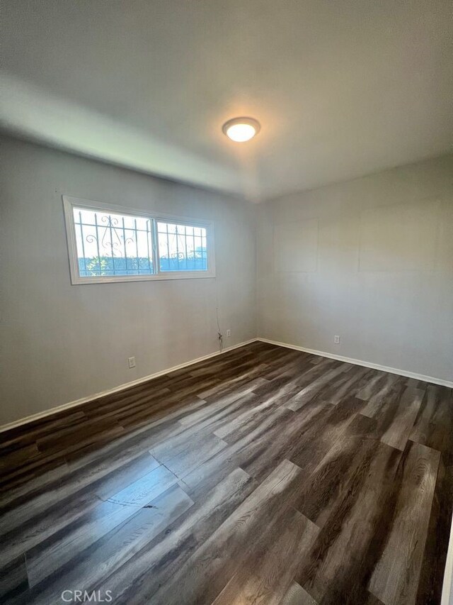 empty room featuring dark wood-type flooring