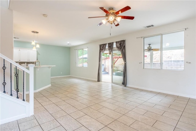 unfurnished room featuring ceiling fan