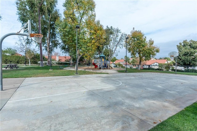 view of sport court featuring a yard and a playground