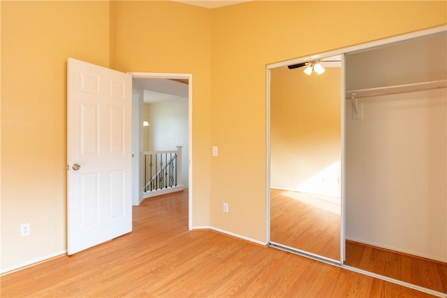 unfurnished bedroom featuring a closet and light hardwood / wood-style floors