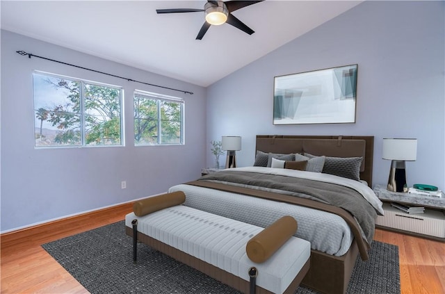 bedroom featuring ceiling fan, wood-type flooring, and vaulted ceiling