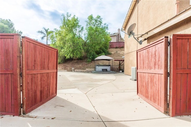 view of gate featuring a patio area