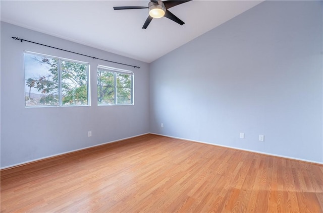 spare room with ceiling fan, lofted ceiling, and light hardwood / wood-style floors