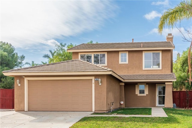 view of property with a front lawn and a garage