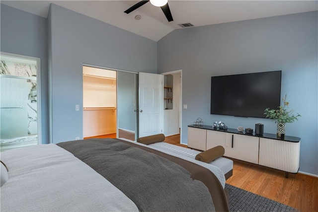 bedroom with ceiling fan, lofted ceiling, light hardwood / wood-style floors, multiple windows, and a closet