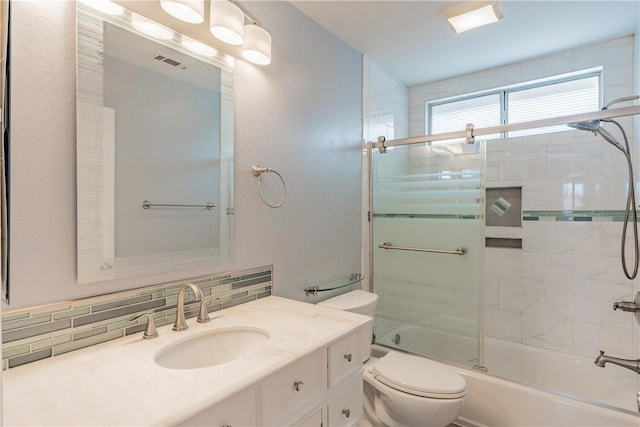 full bathroom with toilet, combined bath / shower with glass door, decorative backsplash, and vanity