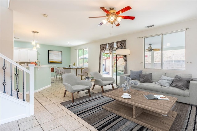 tiled living room featuring ceiling fan