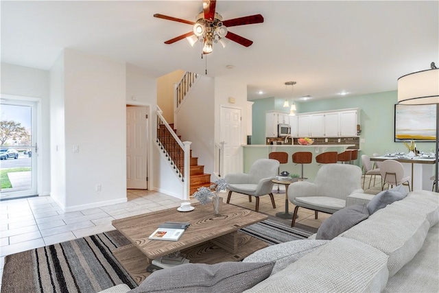 tiled living room featuring ceiling fan