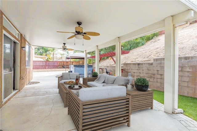 view of patio with outdoor lounge area and a hot tub