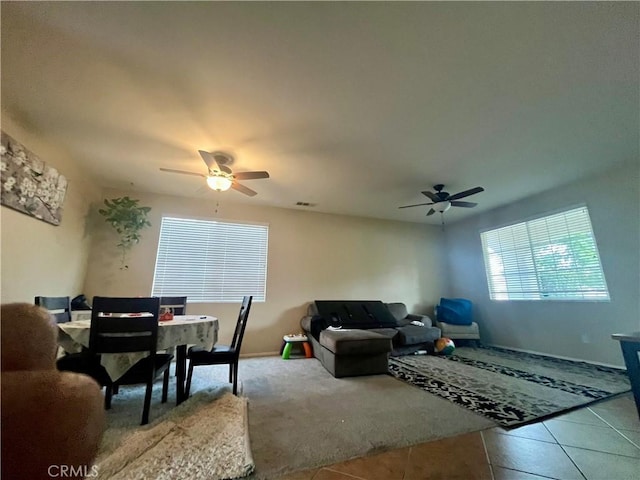 living room with ceiling fan and tile patterned flooring