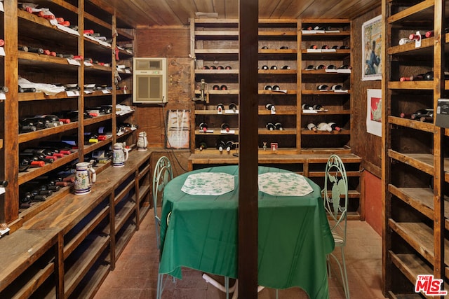 wine room with an AC wall unit and wooden ceiling