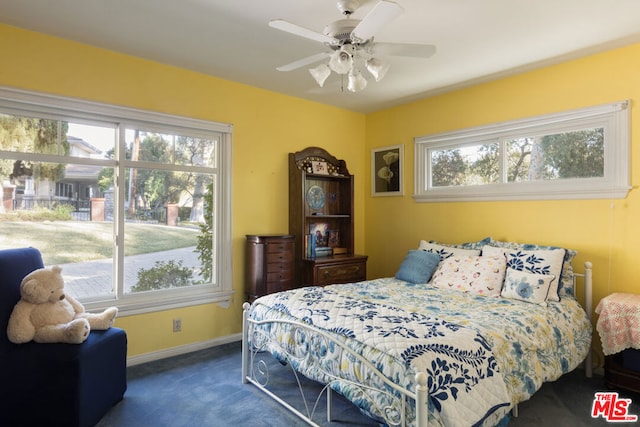 bedroom featuring ceiling fan and dark carpet