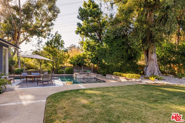 view of yard featuring a pool with hot tub and a patio