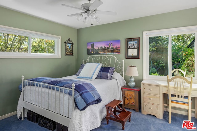 carpeted bedroom with ceiling fan and multiple windows