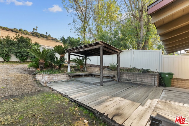 wooden terrace featuring a gazebo