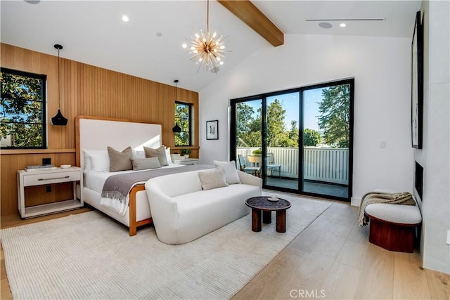 bedroom featuring vaulted ceiling with beams, wooden walls, access to exterior, a notable chandelier, and light hardwood / wood-style flooring