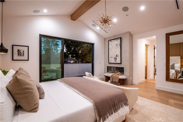 bedroom with access to outside, vaulted ceiling with beams, and light hardwood / wood-style floors