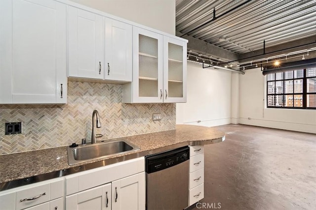 kitchen featuring sink, white cabinets, stainless steel dishwasher, and dark stone counters