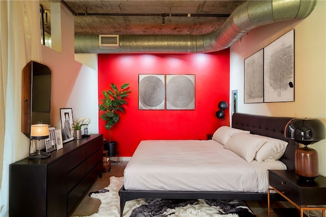 bedroom featuring dark hardwood / wood-style flooring