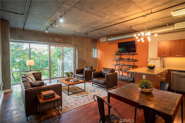 living room with an inviting chandelier and dark hardwood / wood-style floors