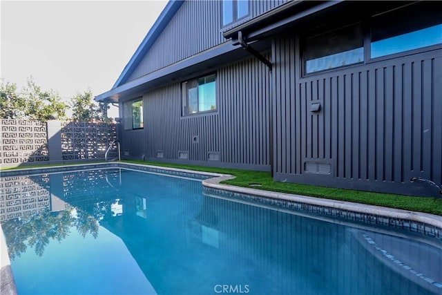 view of swimming pool with a fenced in pool