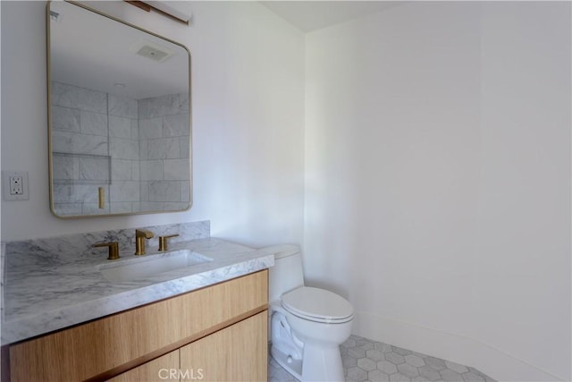 bathroom featuring toilet and vanity