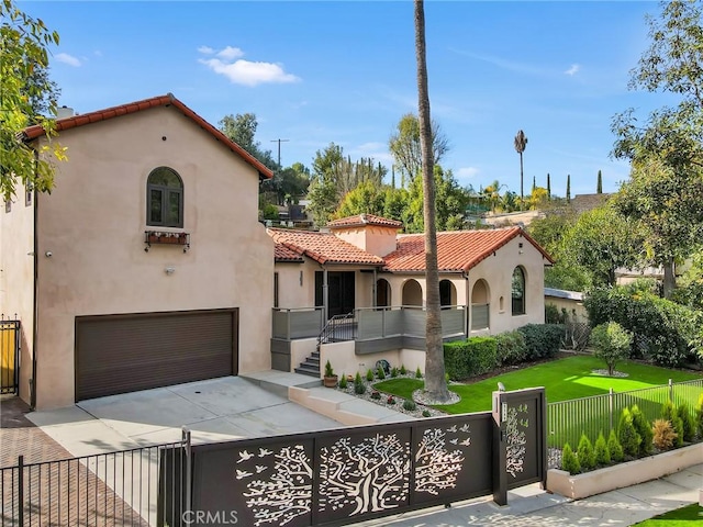 mediterranean / spanish-style house with a front lawn and a garage