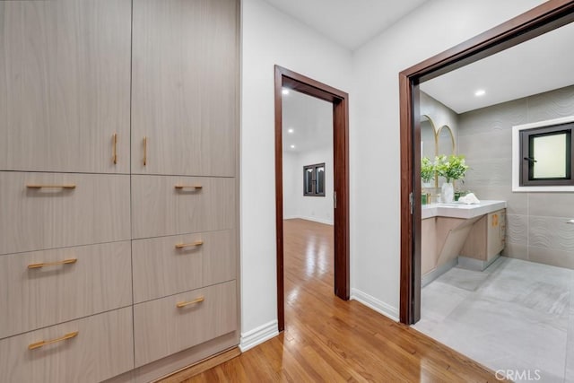 hallway with light hardwood / wood-style flooring