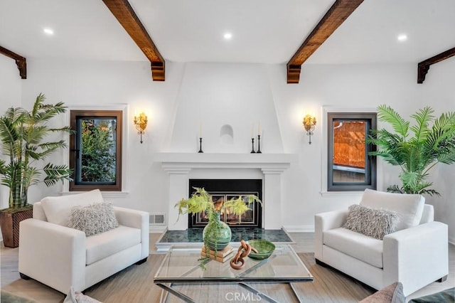 interior space with a fireplace, light hardwood / wood-style floors, and beam ceiling