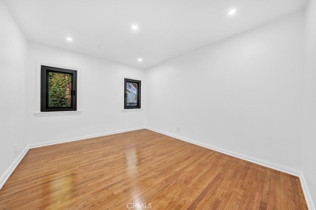 unfurnished room with light wood-type flooring