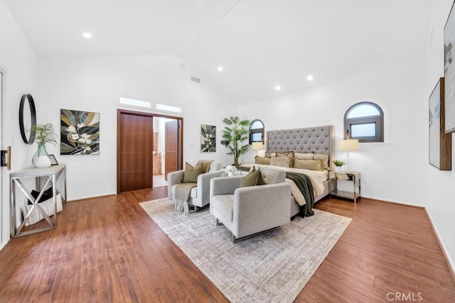 bedroom featuring beam ceiling, high vaulted ceiling, and hardwood / wood-style floors